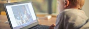 Young child watching video on laptop