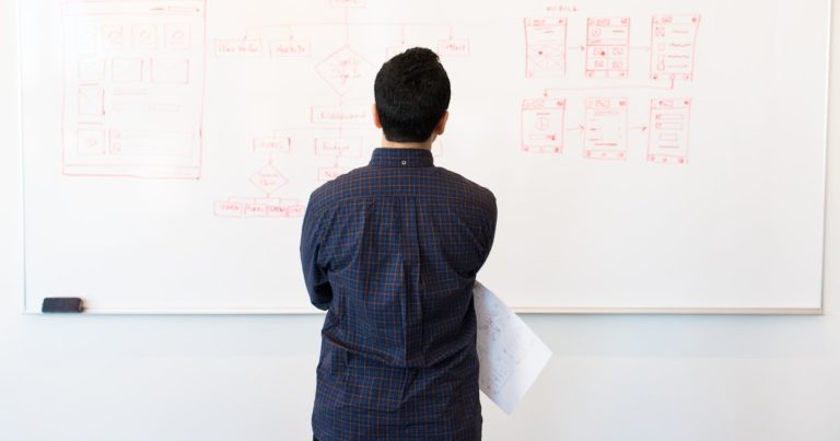 Man standing in front of white board